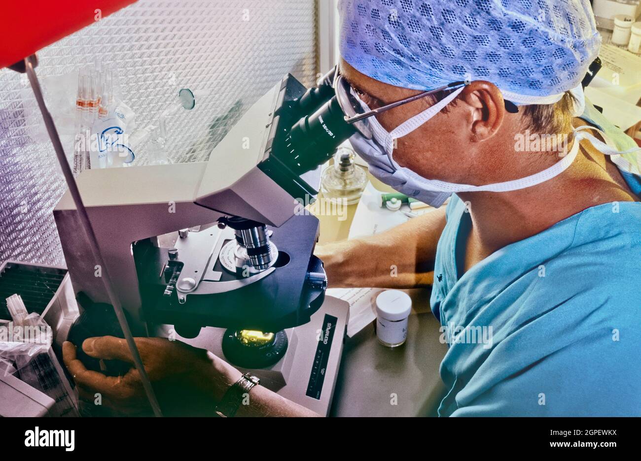 A technician in a specialist IVF clinic prepares sperm samples for selection. Stock Photo