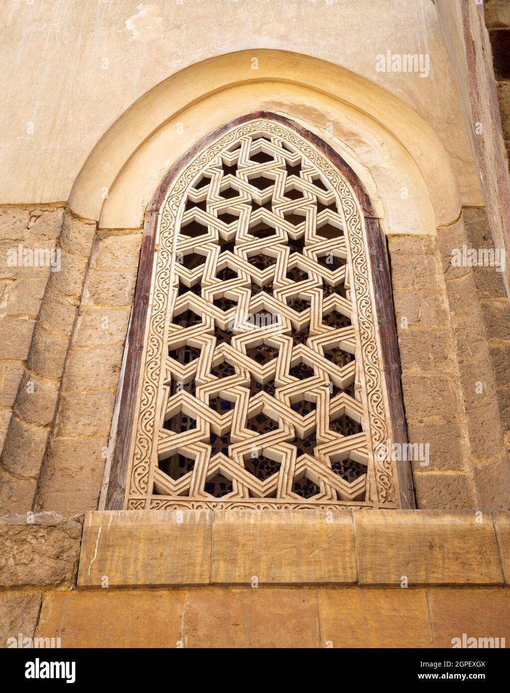 Perforated stucco window decorated with geometrical patterns, located at Mamluk era public historical Qalawun complex, Moez Street, Cairo, Egypt Stock Photo