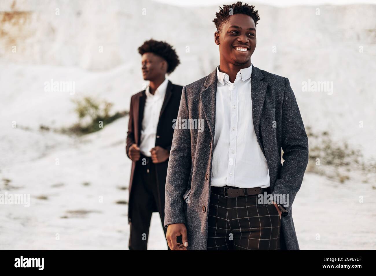 Full body pose of young african male model posing in casuals with legs  crossed Stock Photo - Alamy