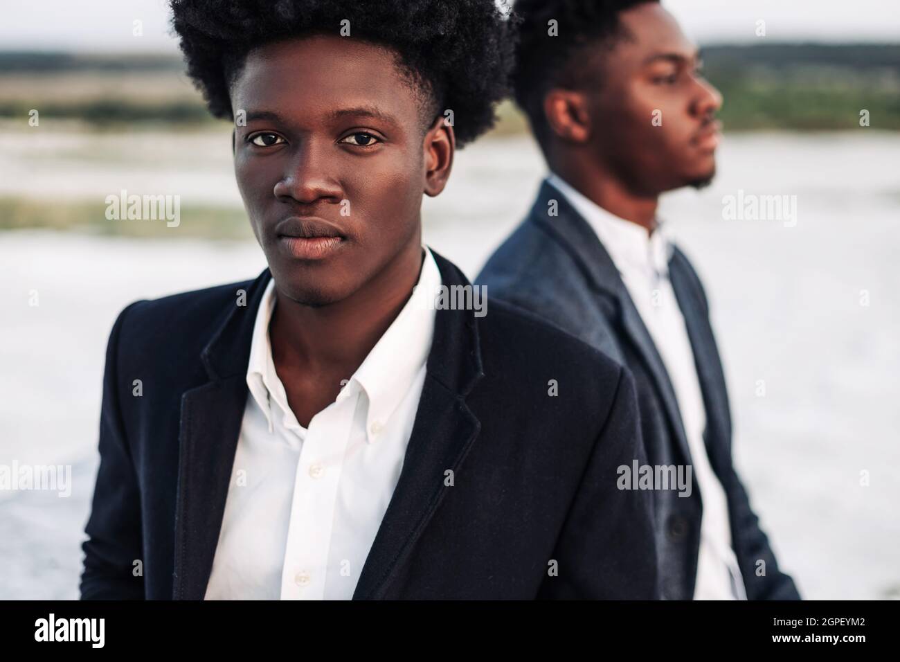 Two trendy African black men, outdoors, in stylish classic clothes, with  fashionable hairstyle, Handsome men, model portrait, Fashion concept, mens  cl Stock Photo - Alamy