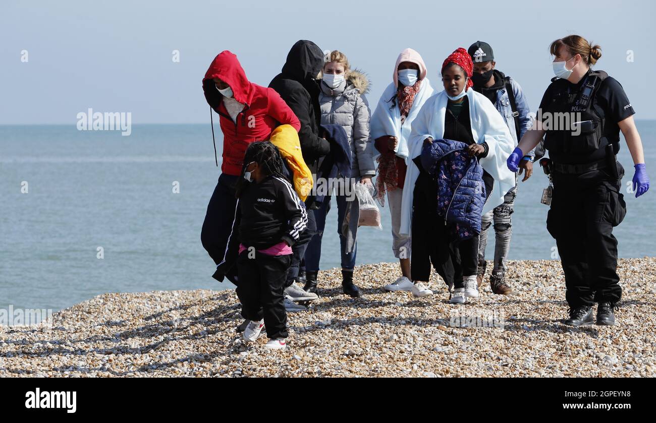 England, Kent, Dungeness, Immigration officers escorting recently landed migrants to be processed, Susina 5yrs old and traveled with her mum from Eritrea. Stock Photo