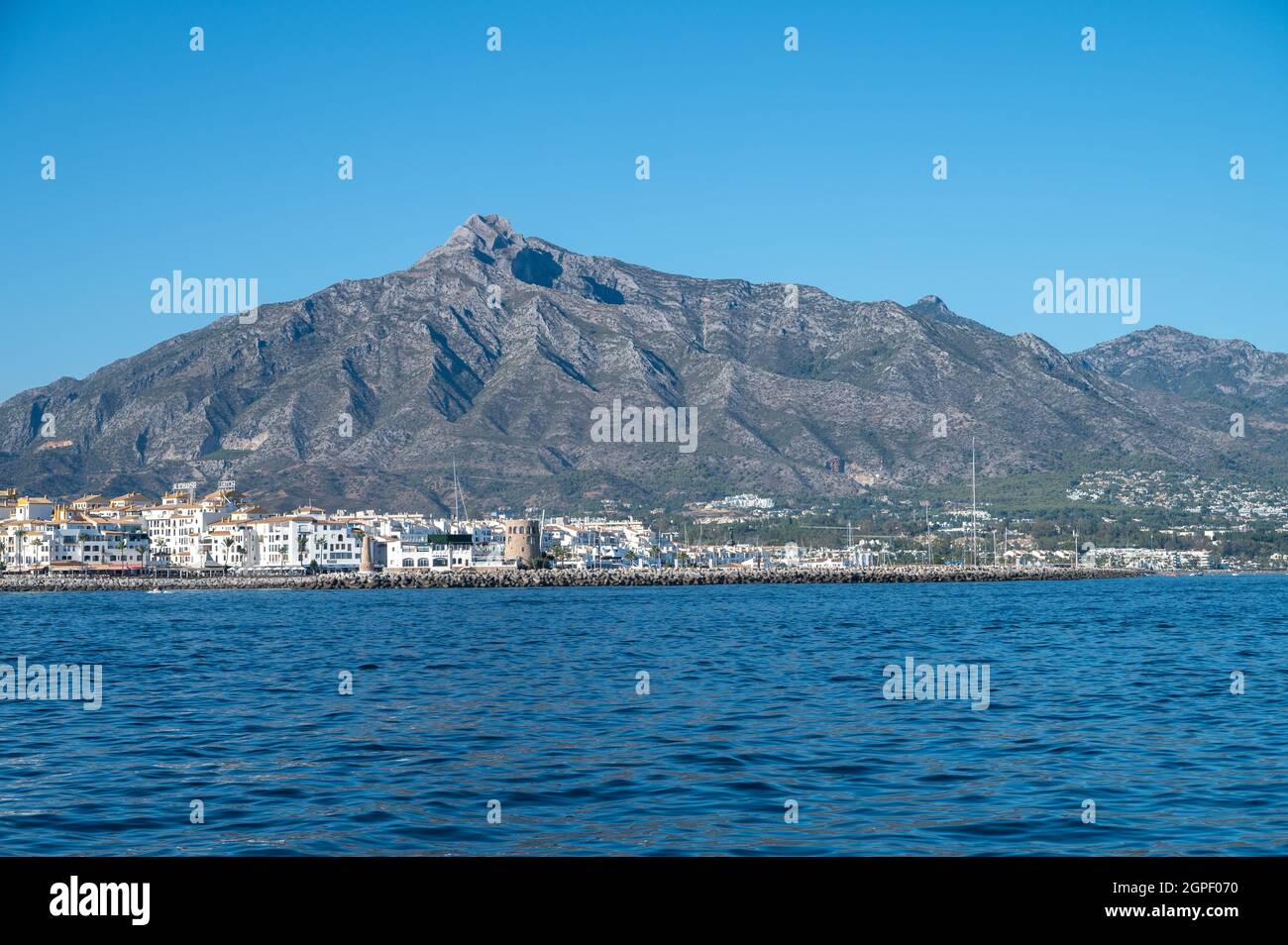 entrance of the famous port of the south of spain, puerto jose banus. the protrective wall and mast of yacths can be seing Stock Photo