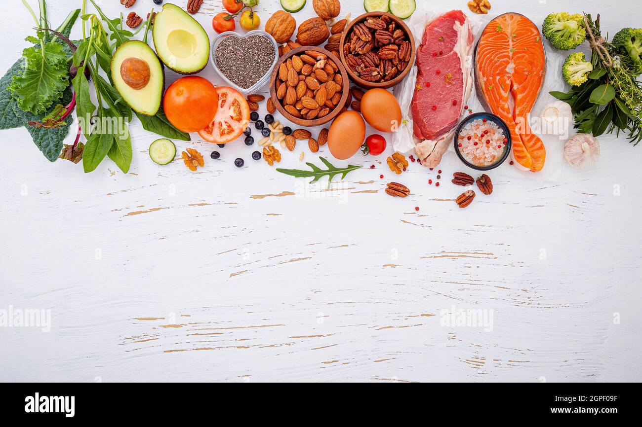 Ketogenic low carbs diet concept. Ingredients for healthy foods selection on white wooden background. Balanced healthy ingredients of unsaturated fats Stock Photo