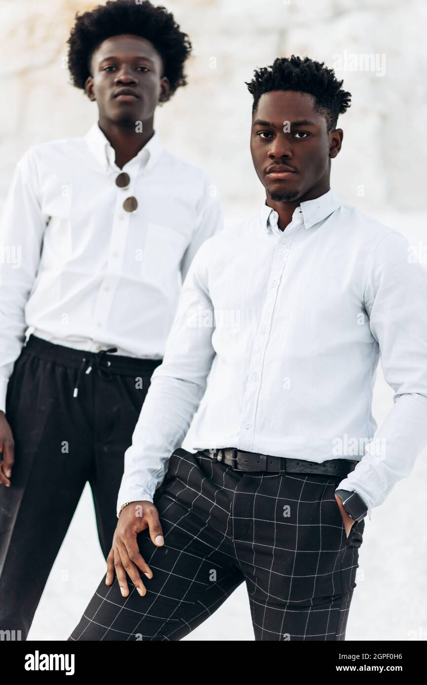 Two trendy black men, fashion portrait of African American male models, in  white shirts, outdoors against the background of chalk mountains and rocks  Stock Photo - Alamy