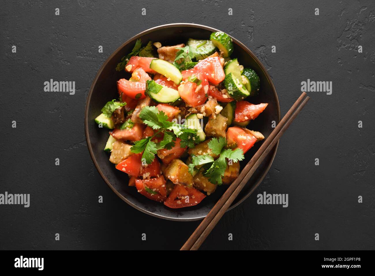 Chinese crispy spicy eggplant with cucumber, garlic, tomatoes, fresh