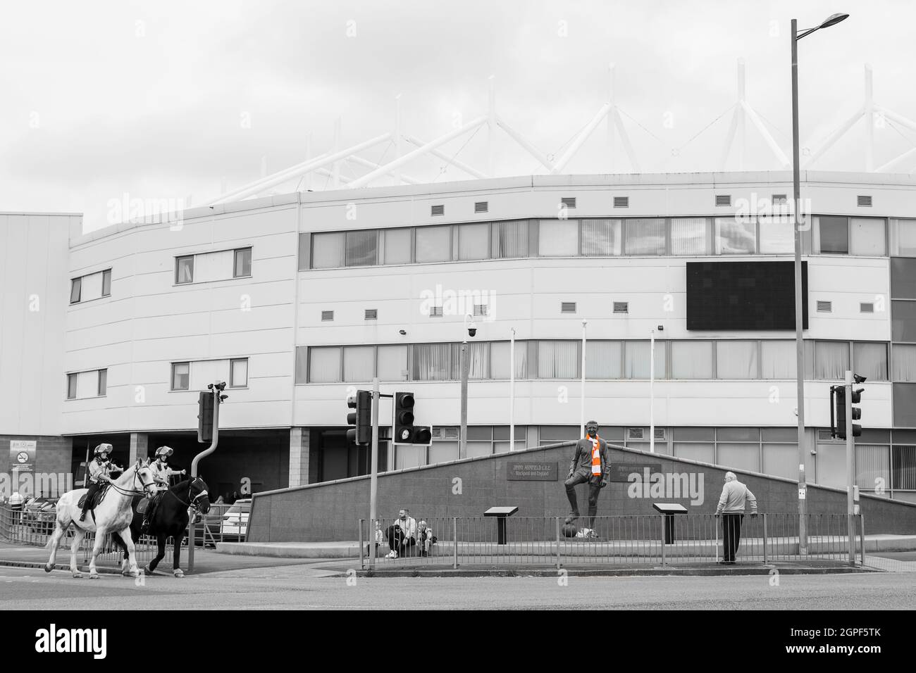 Police on horseback outside Bloomfield Road stadium on a matchday in September 2021 as Blackpool FC welcomed Barnsley FC.  Selective colour has been u Stock Photo