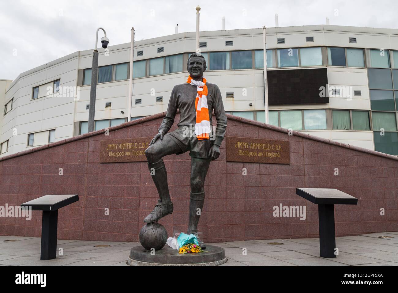A statue of the Blackpool FC legend Jimmy Armfield who spent his entire Football League career at Blackpool pictured in an orange and white scarf on a Stock Photo