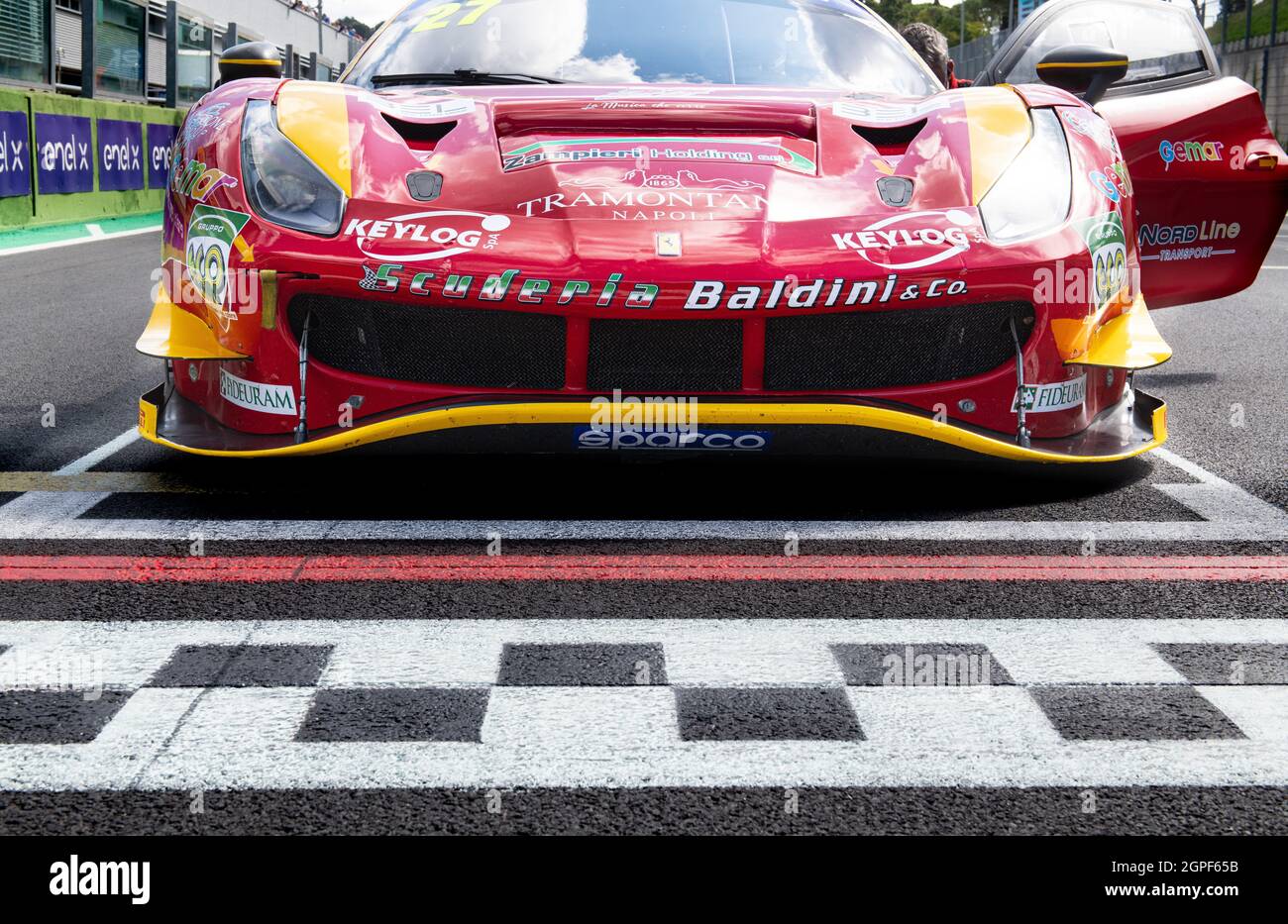 Vallelunga, italy september 19th 2021 Aci racing weekend. Red Ferrari 488 GT low angle view close up on asphalt circuit checkered line Stock Photo