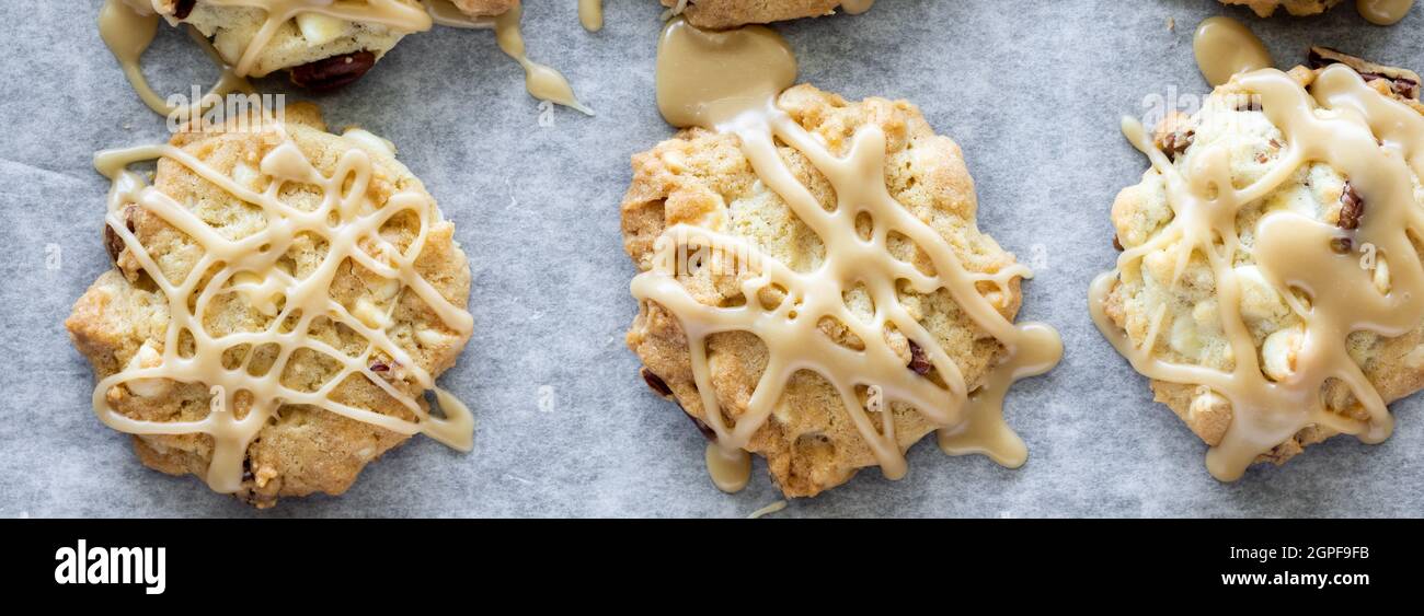 Top down narrow view of maple Vermont cookies drizzled with maple icing. Stock Photo