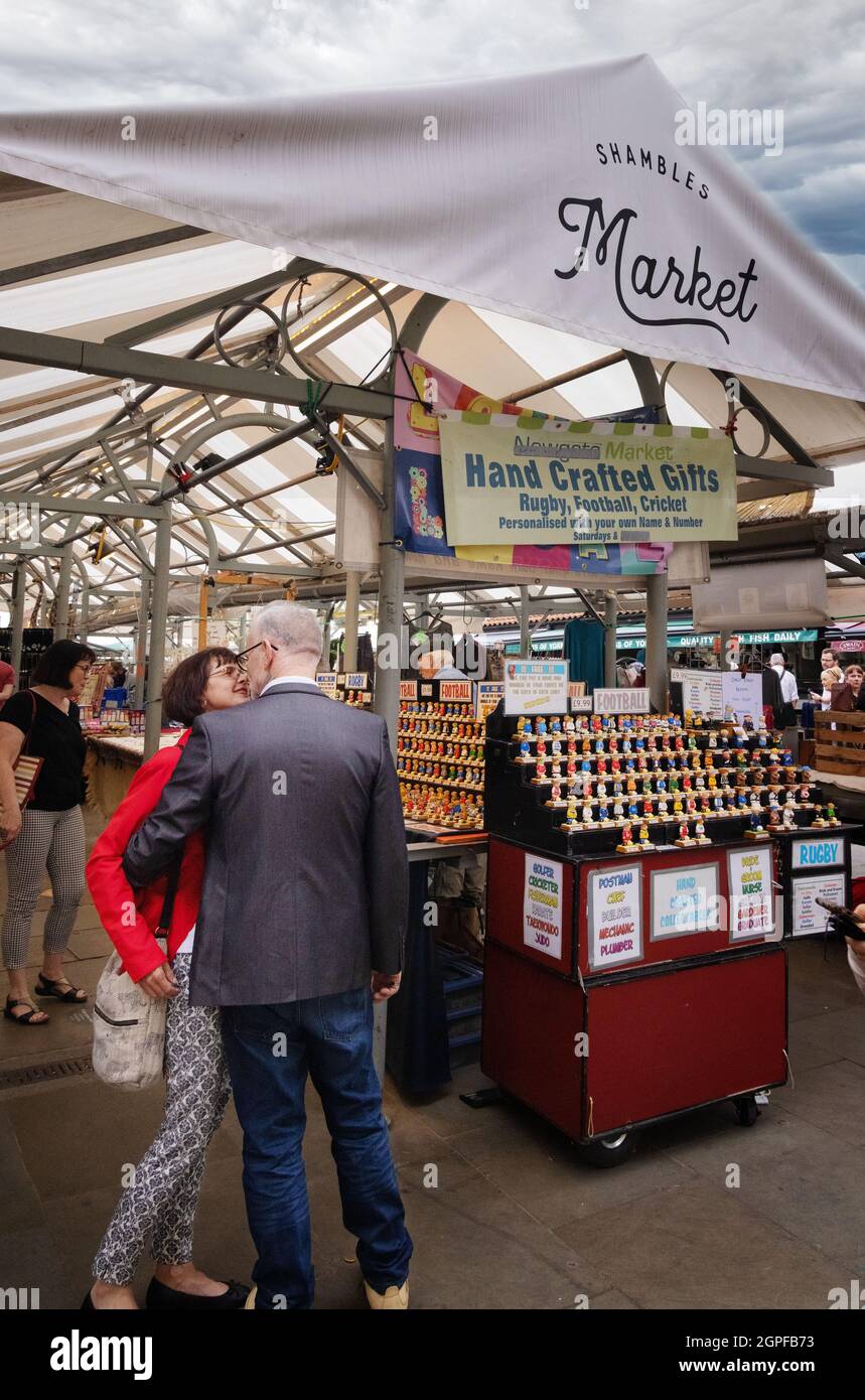 Street photography UK; a middle aged couple kissing on the street, The Shambles market, the Shambles York UK Stock Photo