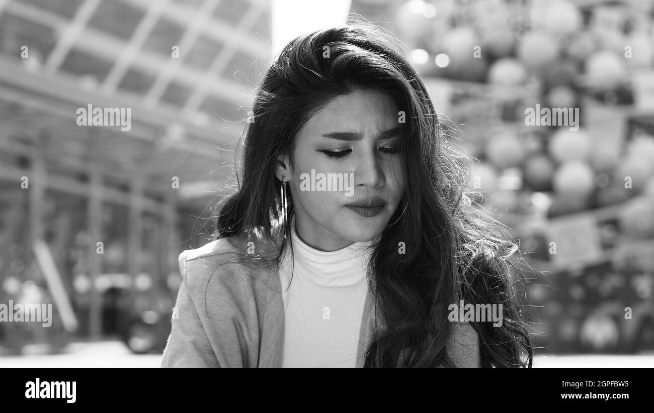 Lay off. Sacked. Fired business woman sitting on stairs of office building outside. Depressed young business woman unemployment due to coronavirus cri Stock Photo