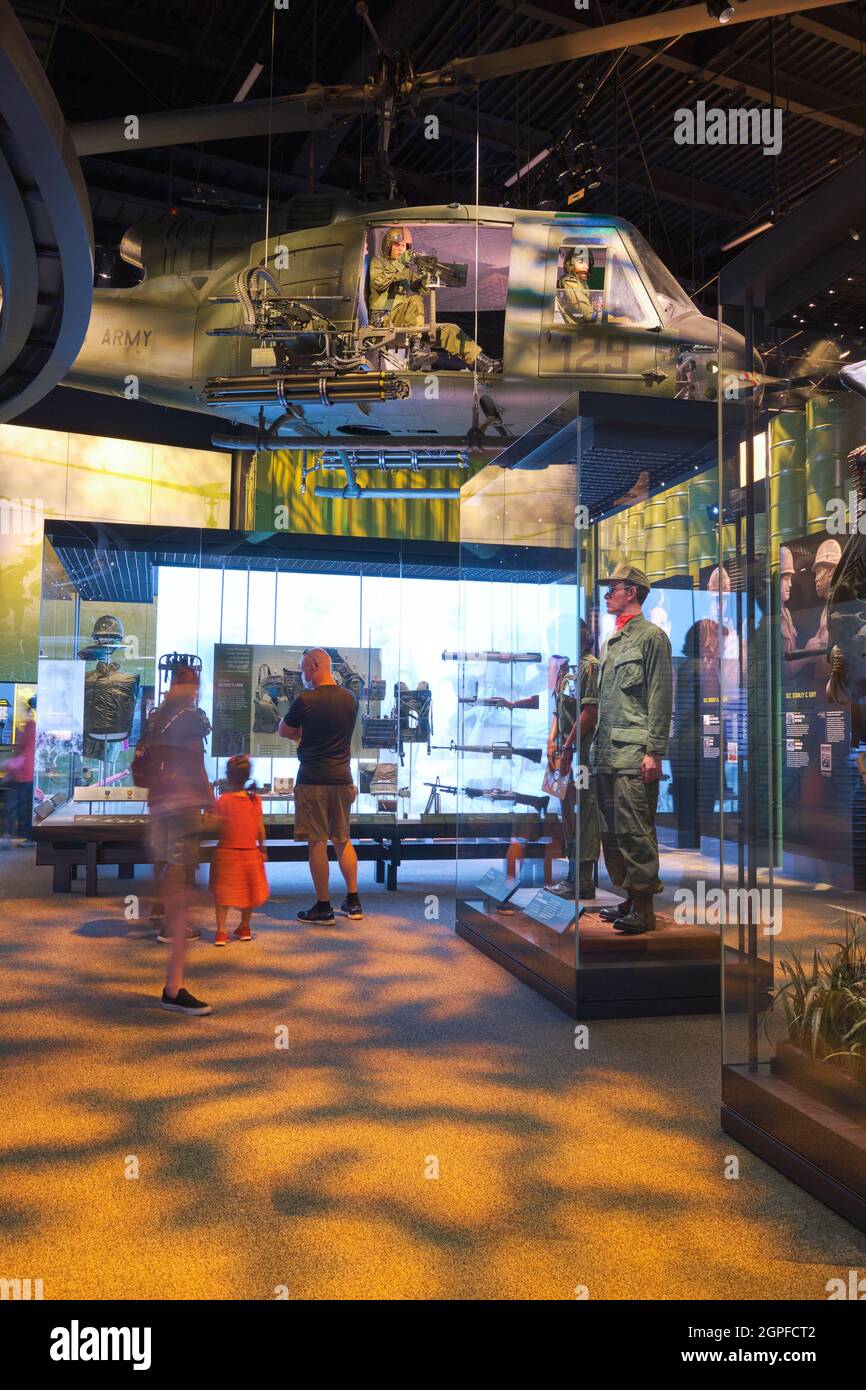 A Bell UH-1 Iroquois, Huey helicopter witn gunner and various soldier uniforms in the Vietnam gallery, room. At the National Museum of the United Stat Stock Photo