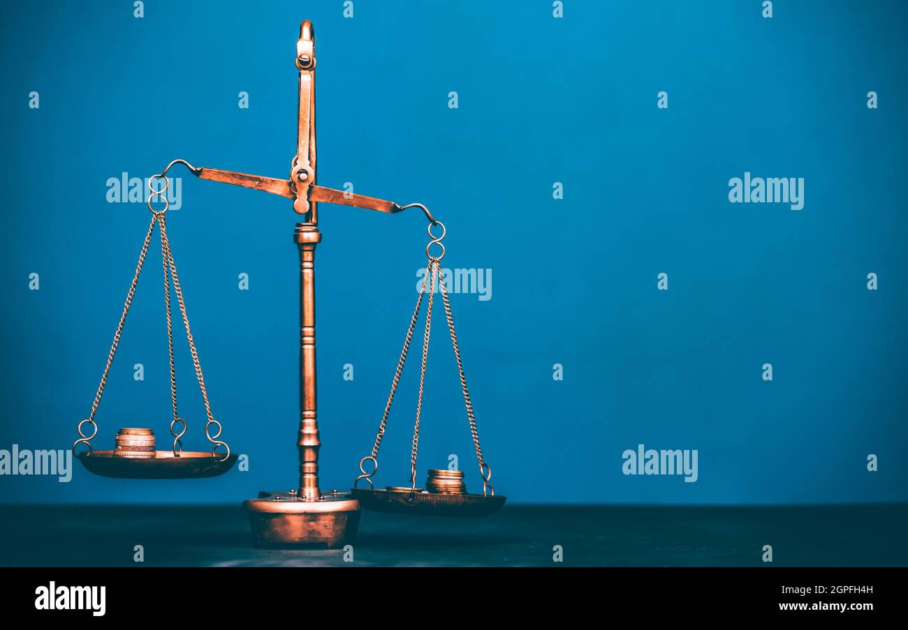 Balance scale with coin stacks. Money management, time value of money