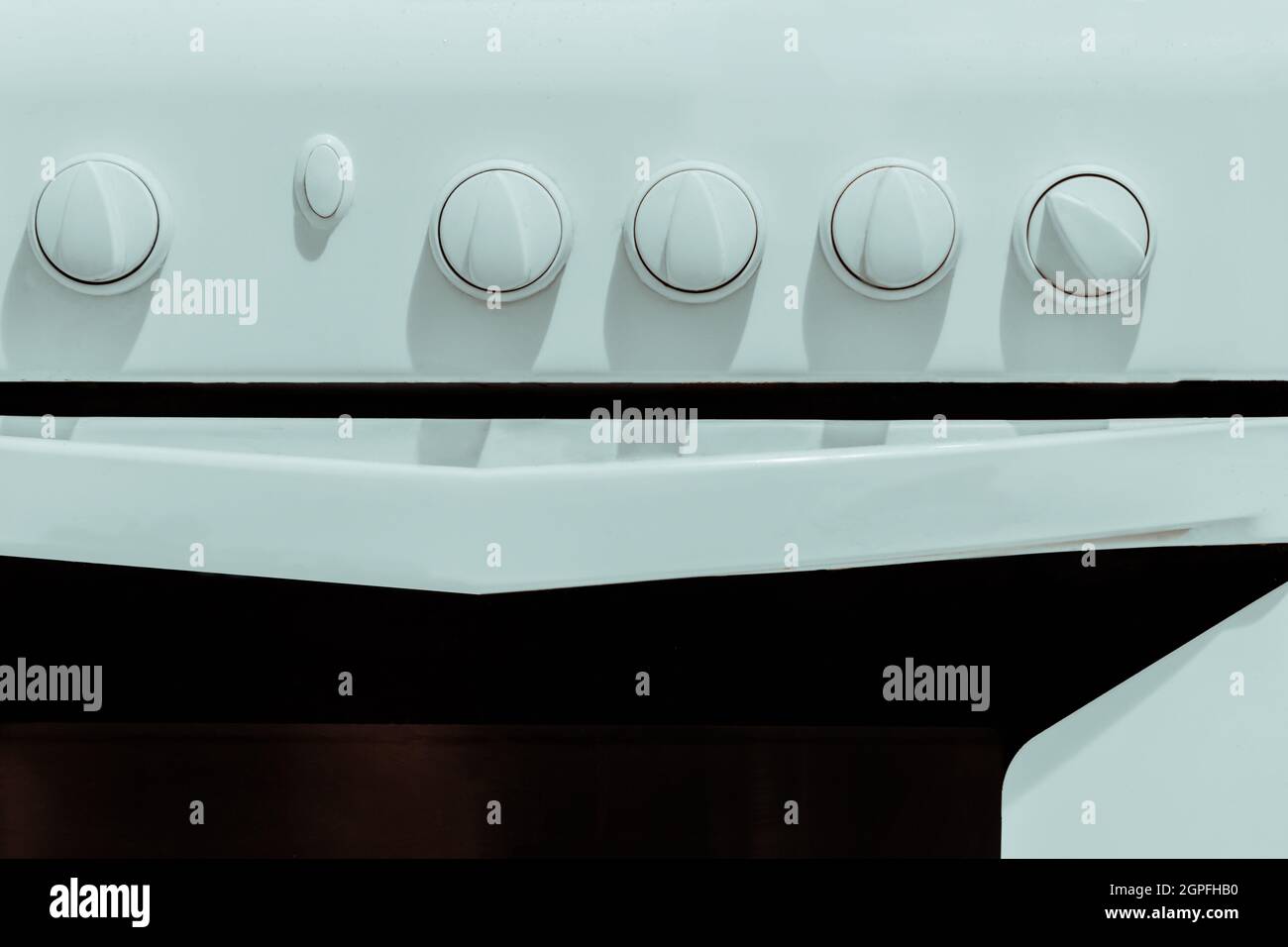 White kitchen gas stove with knobs for adjusting closeup Stock Photo