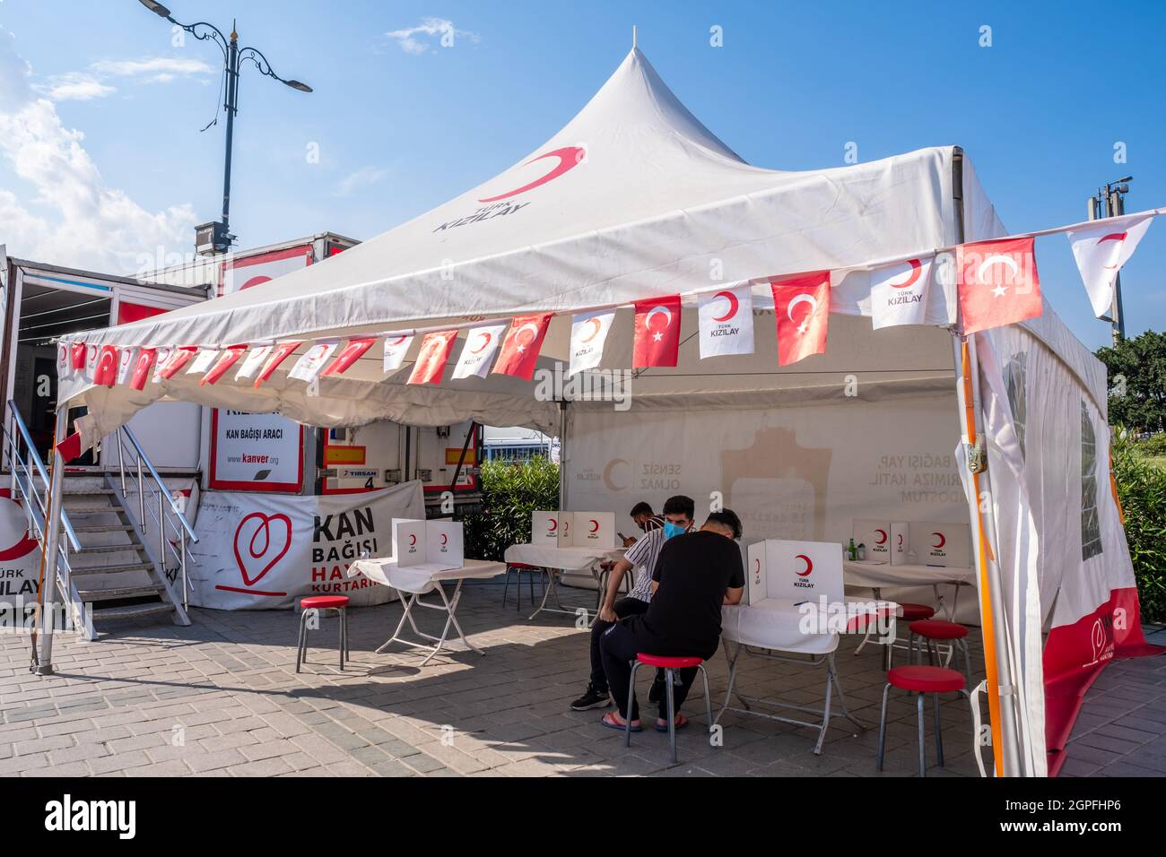 Eminonu, Istanbul, Turkey - 07.05.2021: tent of Turkish Red Crescent (Turk Kizilay) with Turkish flag and some volunteers sign the official approval d Stock Photo