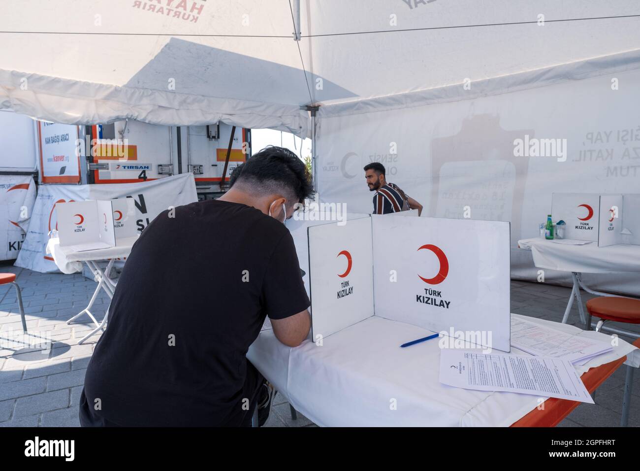 Eminonu, Istanbul, Turkey - 07.05.2021: a male person volunteer signing approval document for blood donation for Turkish Red Crescent (Turk Kizilay) u Stock Photo