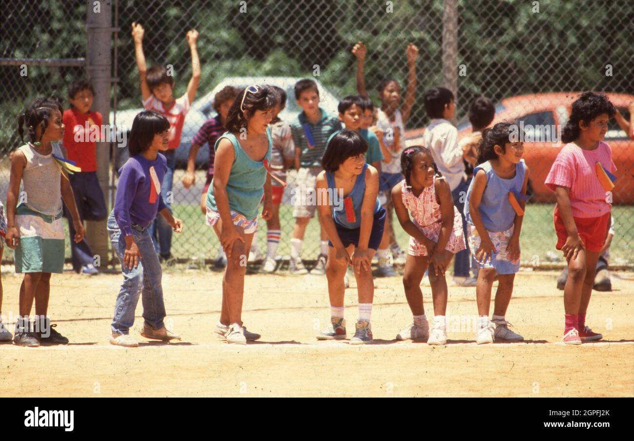 Austin Texas USA, circa 1990: Children's Sports: Second- through fifth-grade girls waiting for the starting signal for their race during track and field day at their elementary school. ©Bob Daemmrich Stock Photo