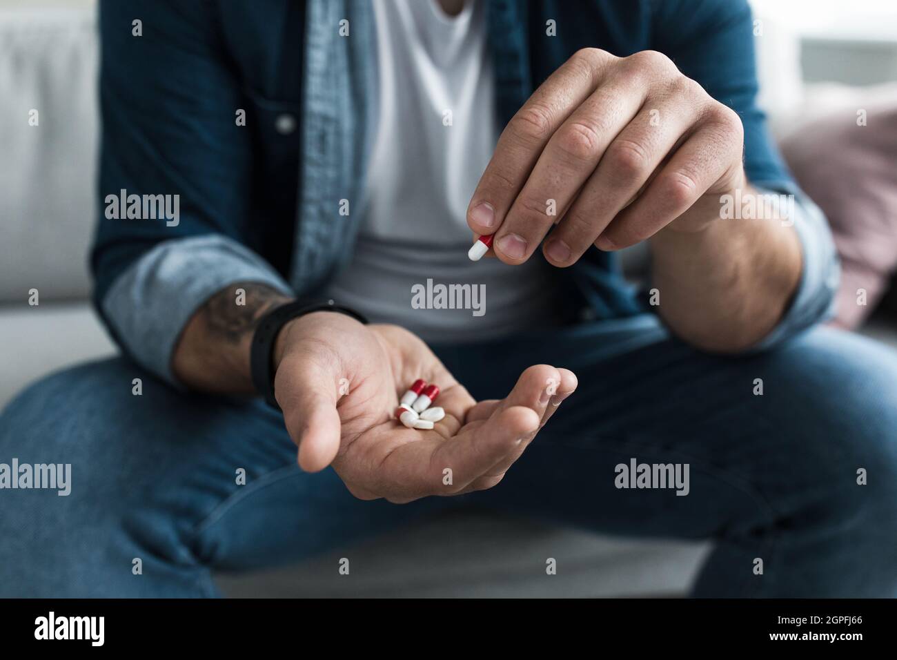 Colorful pharmaceutical medicine pills, narcotic drugs in capsules on palm Stock Photo