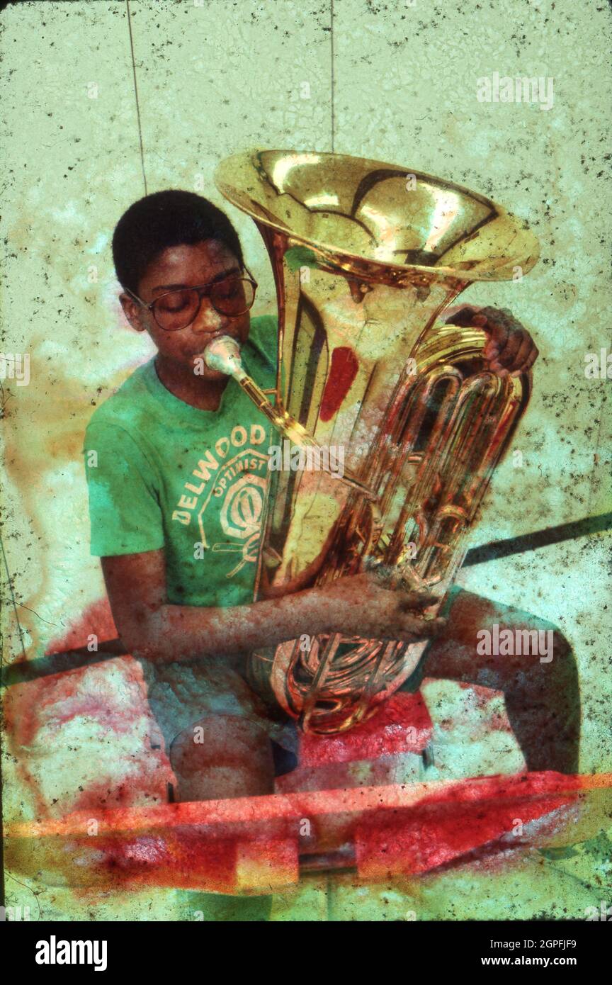 Austin Texas USA, circa 1994: Black junior high music student playing a tuba during band practice. ©Bob Daemmrich Stock Photo