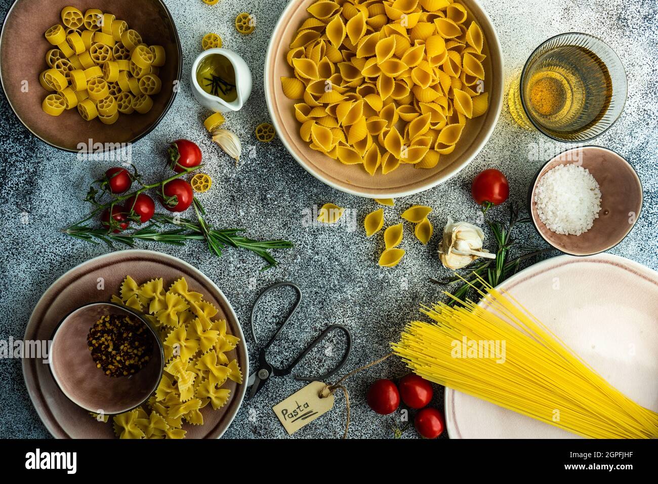 Italian pasta cooking concept with variety of pasta, spices and vegetables Stock Photo