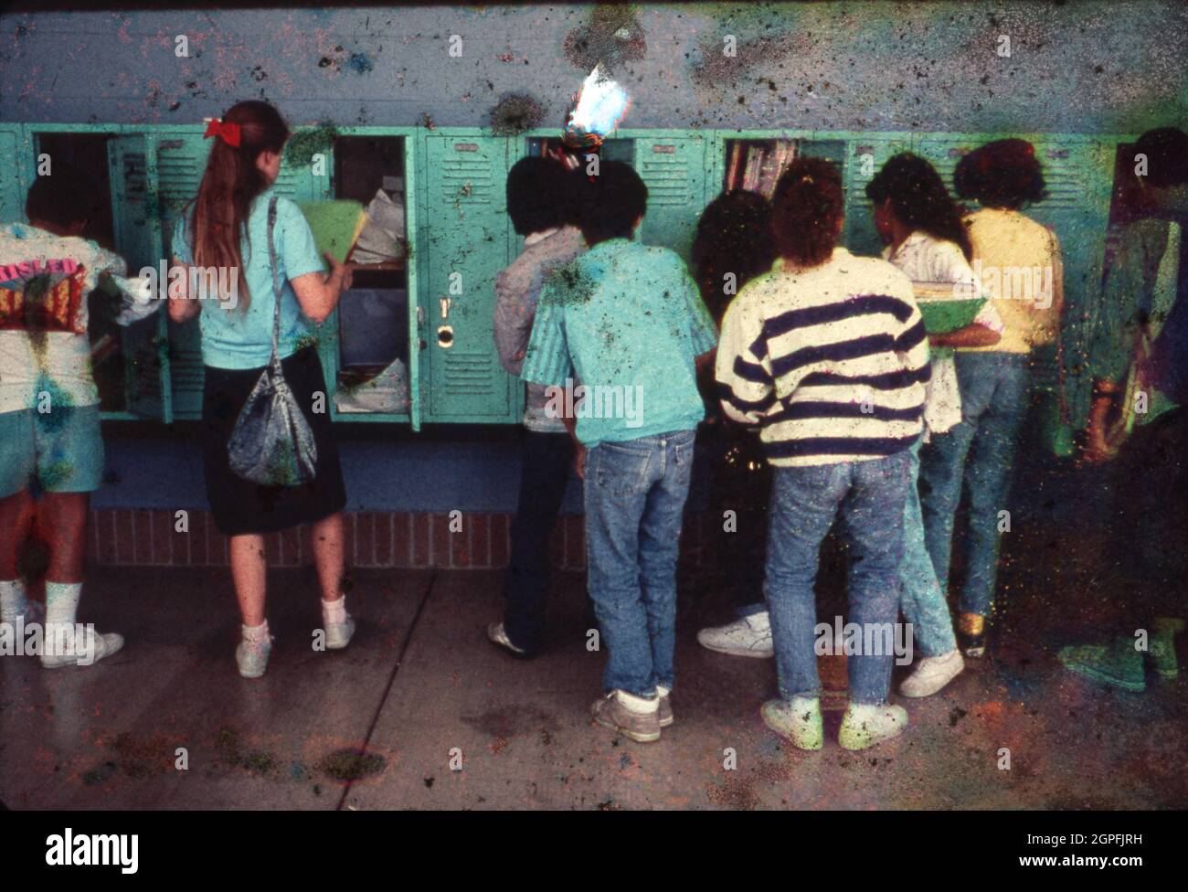 Austin Texas USA, circa 1990: Junior high school students at their lockers during a break between classes. ©Bob Daemmrich Stock Photo