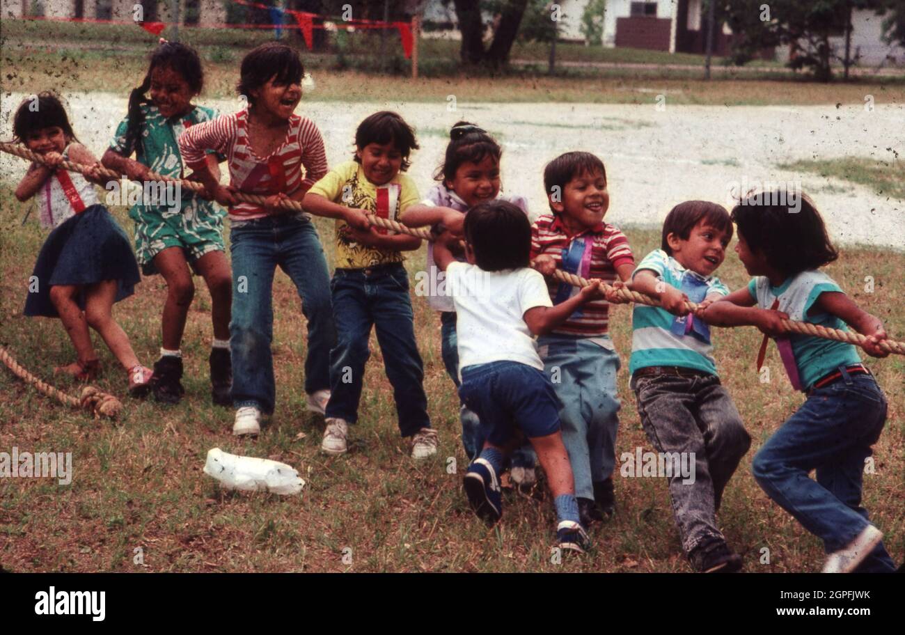 Austin Texas USA, circa 1990: Kindergarten students play a tug-of-war game during school recess.  ©Bob Daemmrich Stock Photo
