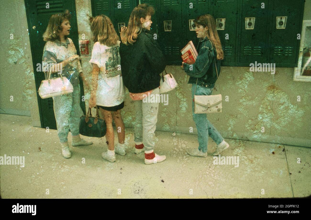 Austin Texas USA, circa 1989: Teen girls socialize at their lockers in the hallway between classes at Bowie High School. ©Bob Daemmrich Stock Photo