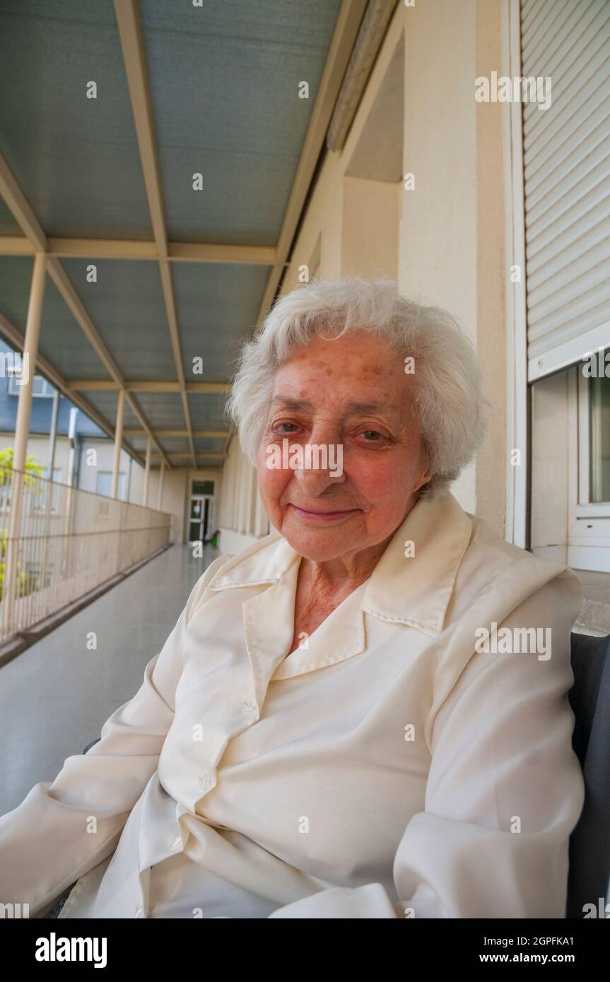 Elderly woman smiling and looking at the camera. Stock Photo