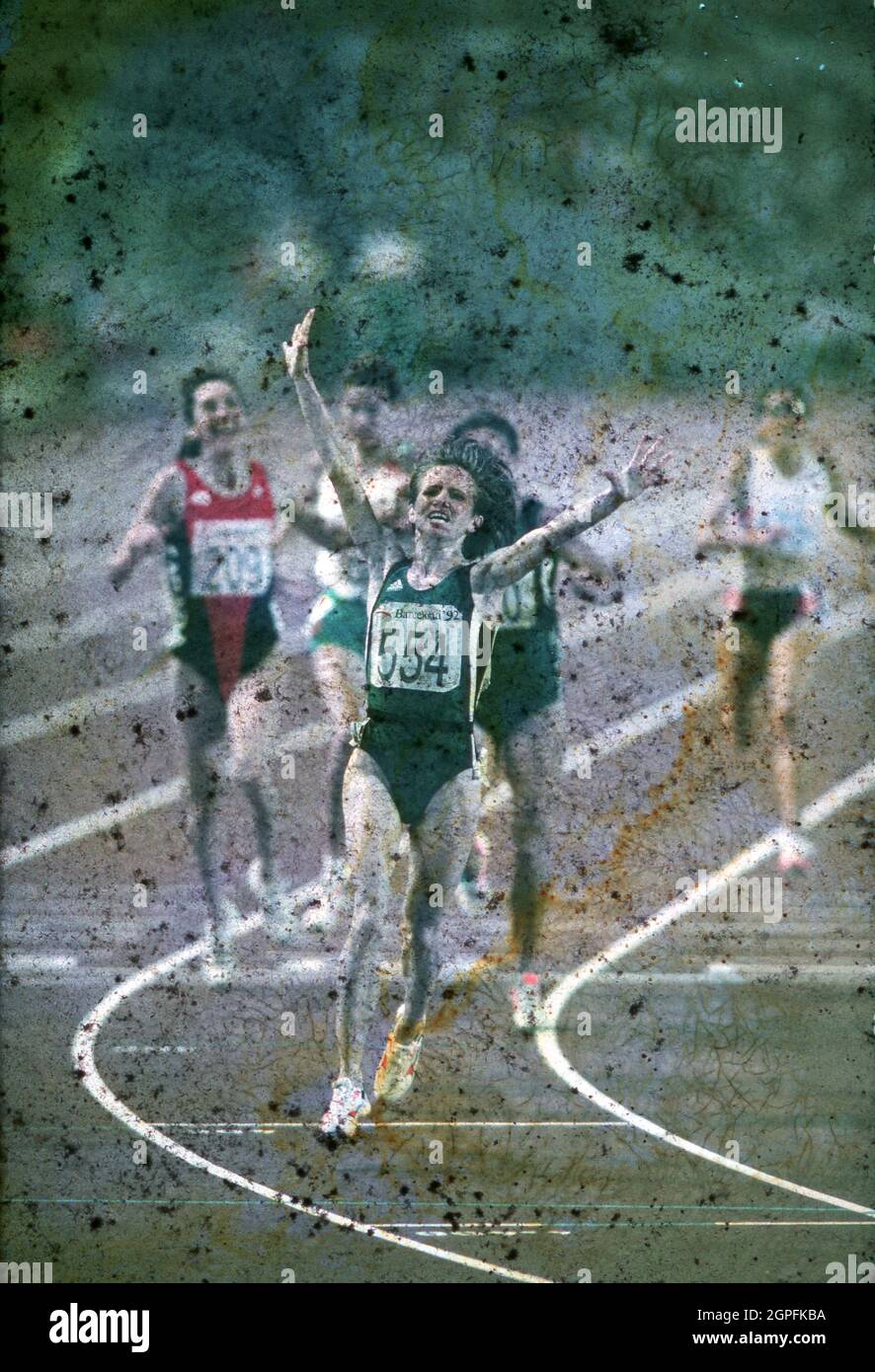 Barcelona Spain 1992: Elena Romanova of the Unified Team celebrates as she crosses the finish line in first place of the women's 3,000-meter race during the 1992 Summer Olympics. ©Bob Daemmrich. Stock Photo