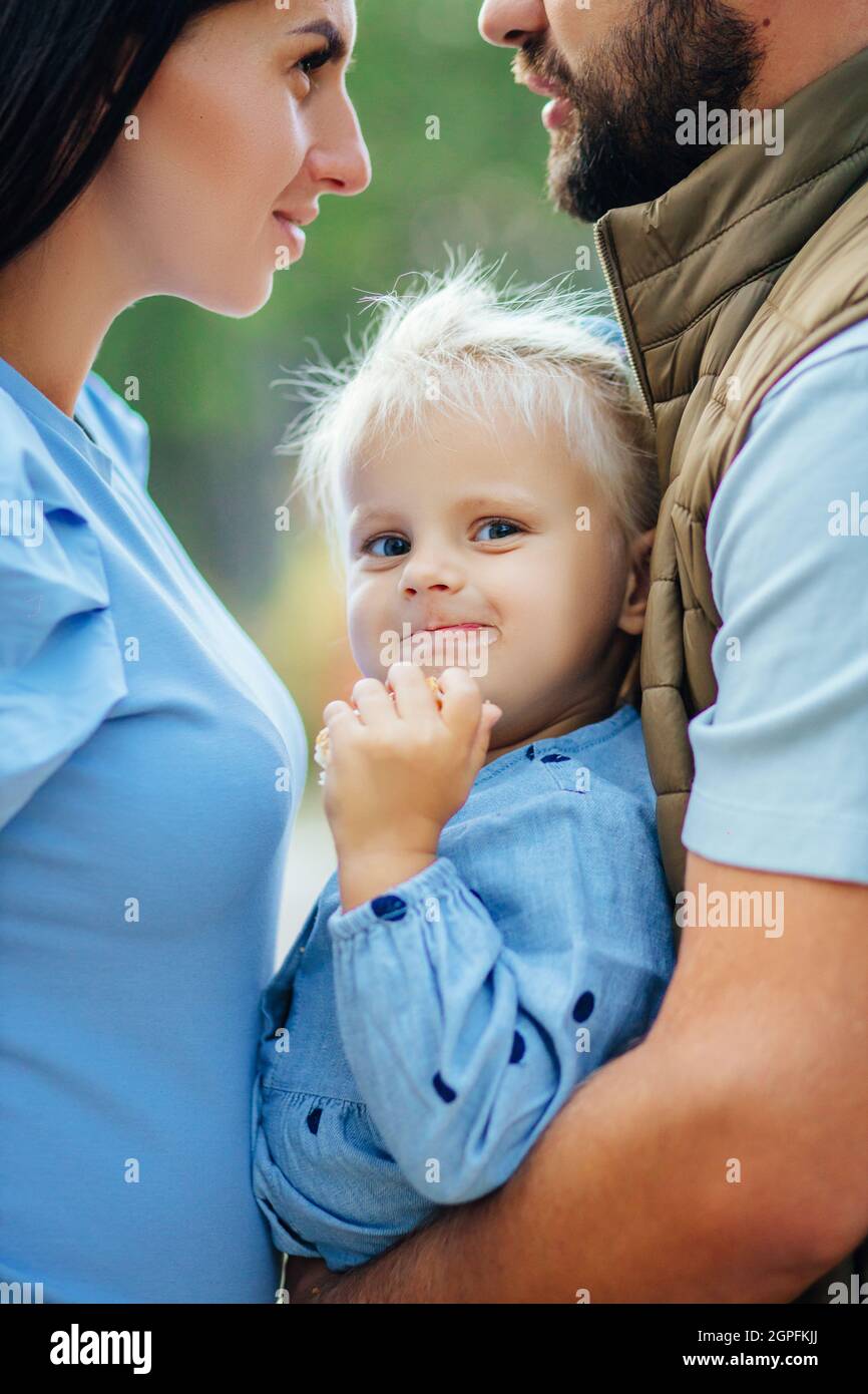 Little white girl in a white blue dress laughs in forest. Preschooler ...