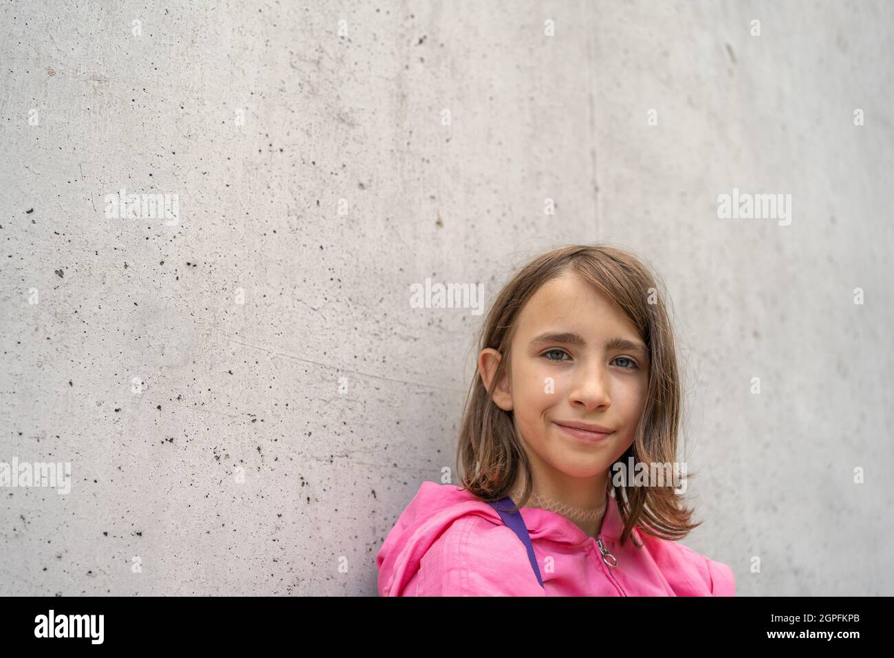 Portrait of teenage girl in front of concret wall Stock Photo - Alamy