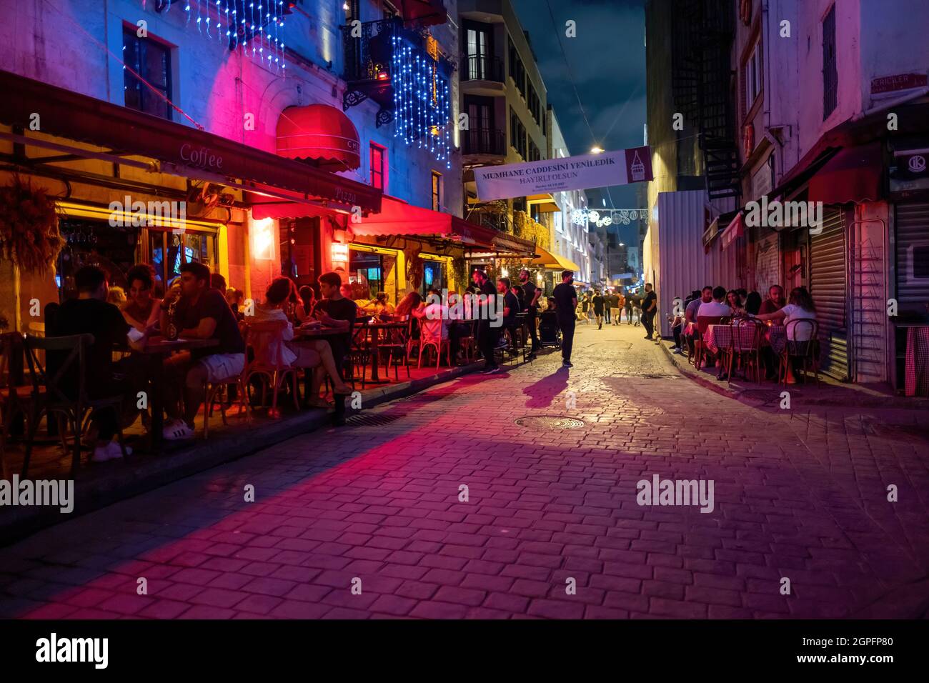Beyoglu, Istanbul, Turkey - 07.07.2021: pink and red colorful colors of entertainment street with some bars disco restaurant and night clubs where peo Stock Photo