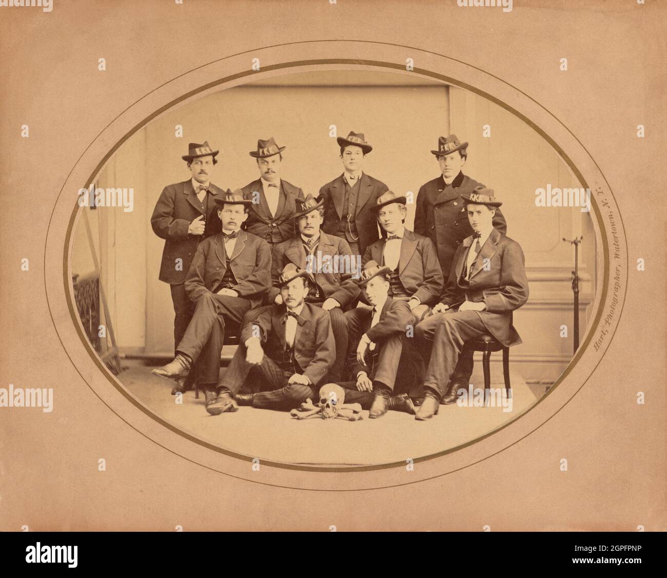 Vintage photo circa 1870 showing members of the Ku Klux Klan New York city Watertown Division 289 wearing KKK hats and posing with a skull and cross bones Stock Photo