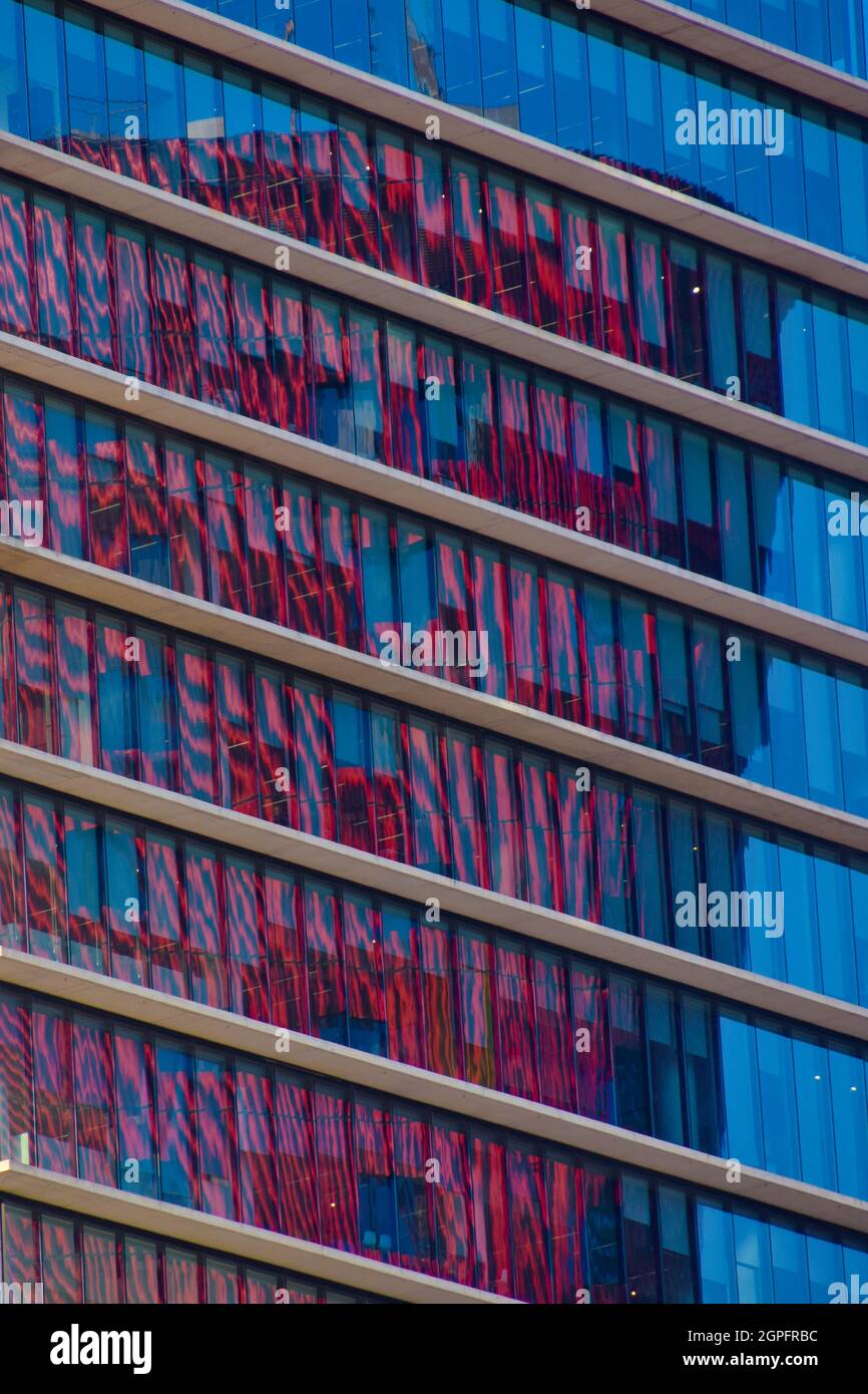 Red building reflections on an office building, close-up. Stock Photo