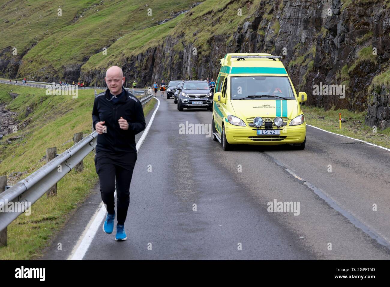 Runner participating in the half marathon from Gasadalur to Sandav‡gur, Vagar Island, Faroe Islands,Europe. Stock Photo
