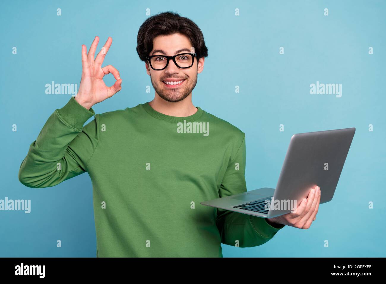 Smiling Computer Nerd Portrait of smiling geek nerd young businessman in glasses show okay ...