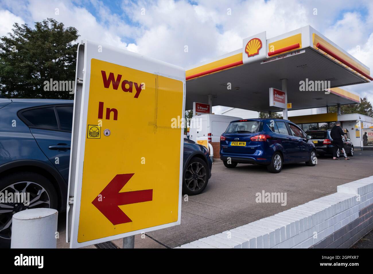 As the fuel crisis in the UK continues, this Shell petrol station is open for business, and motorists drive in with their cars to fill up with fuel, which is being sold at normal prices on 29th September 2021 in Birmingham, United Kingdom. While some forecourts remain closed with little or no fuel, there is confusion amongst the public as to whether they should buy fuel now or wait. This has led to panic buying and long queues outside some petrol stations as the crisis, which has been caused by a lack of HGV drivers available to deliver supplies, continues. Stock Photo