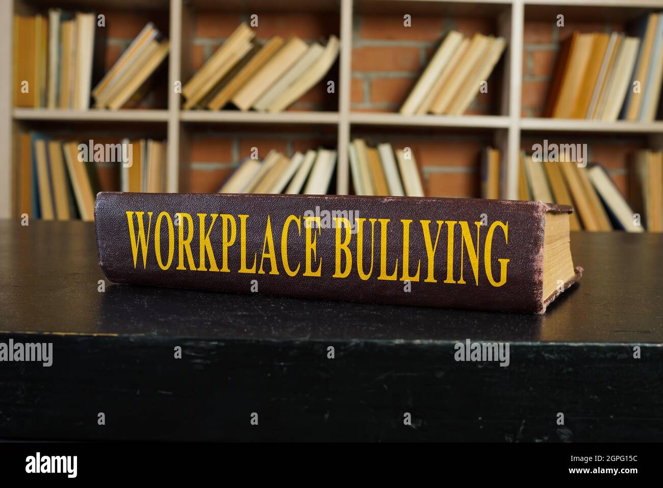 Book with rules about workplace bullying on the surface. Stock Photo
