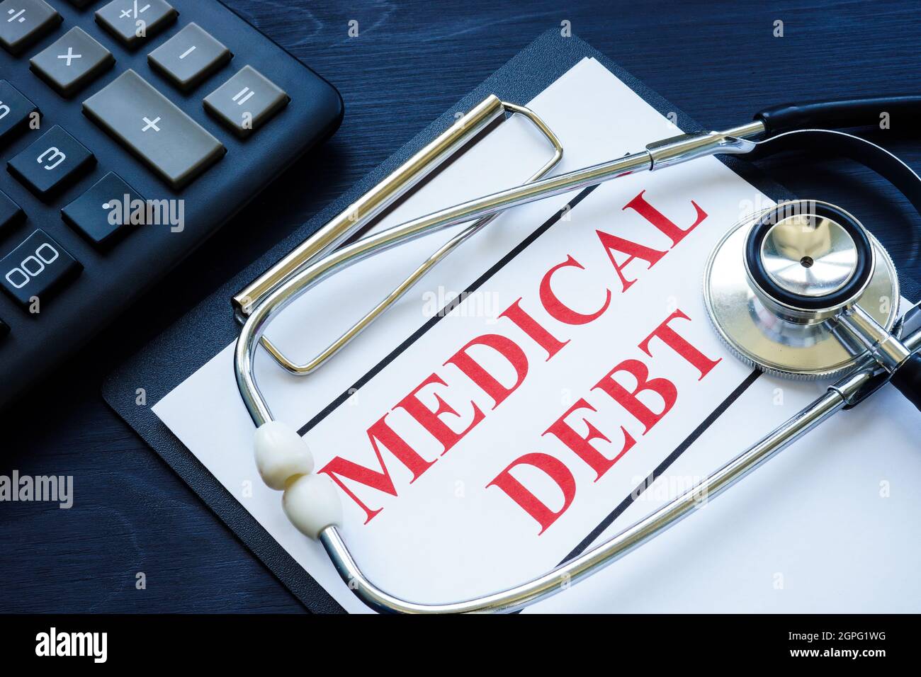 Medical debt bill in the clipboard and stethoscope. Stock Photo