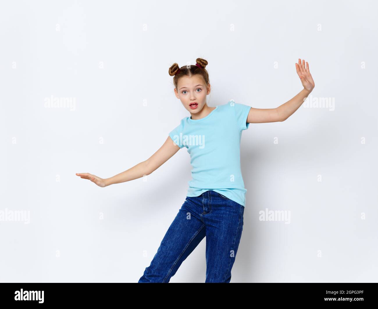 happy little girl with hairstyle blue t-shirt jeans model Stock Photo -  Alamy