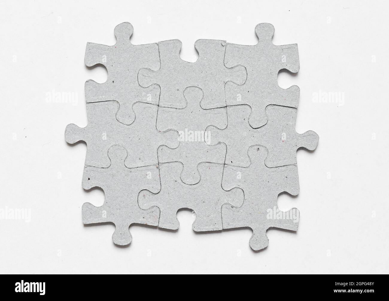Photo of jigsaw puzzle pieces fit together on white background Stock