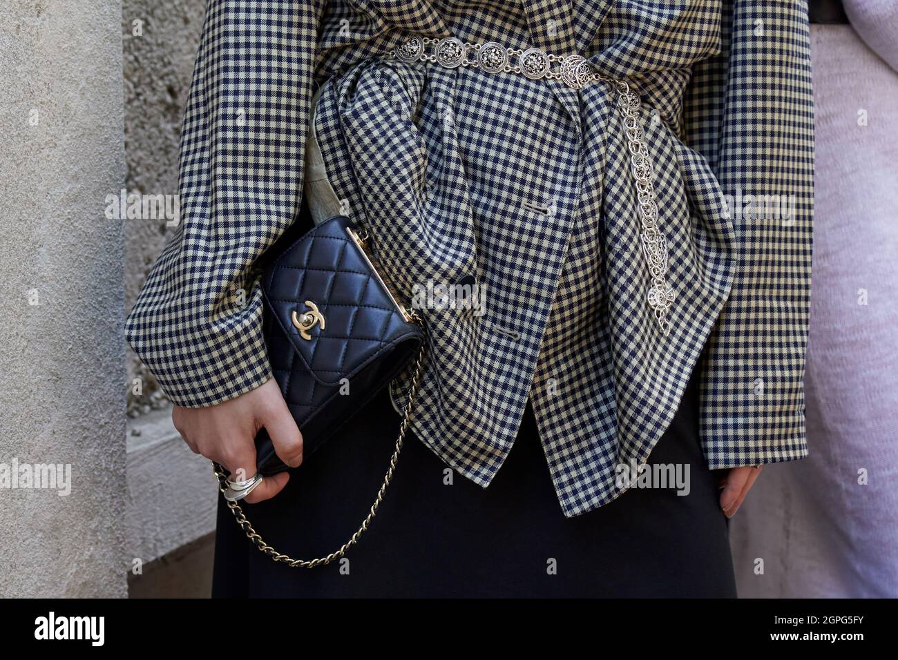 MILAN, ITALY - SEPTEMBER 24, 2021: Woman with black leather Chanel bag and  checkered jacket before Prada fashion show, Milan Fashion Week street style  Stock Photo - Alamy