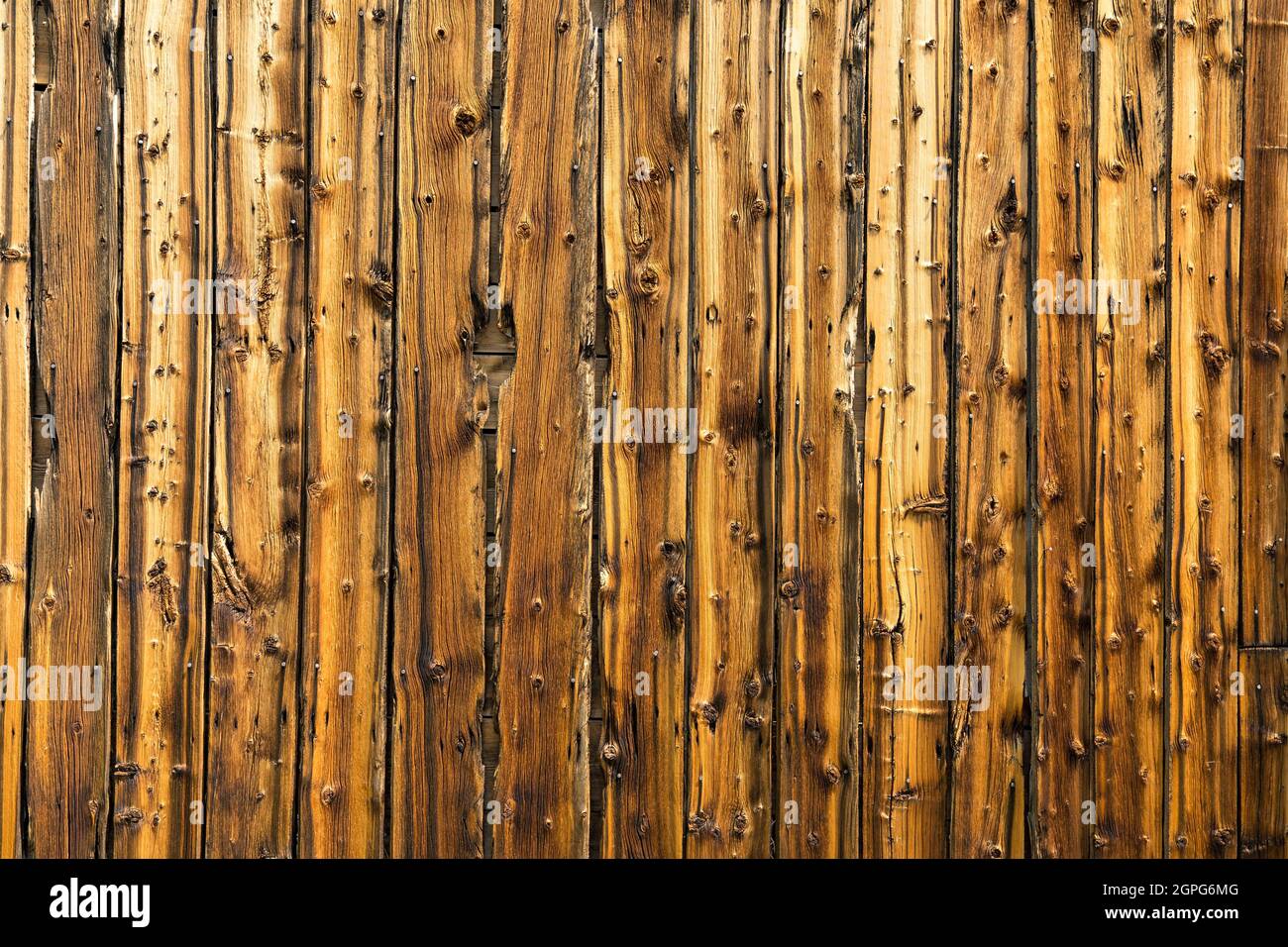 Old weathered vertical barn wood siding background Stock Photo