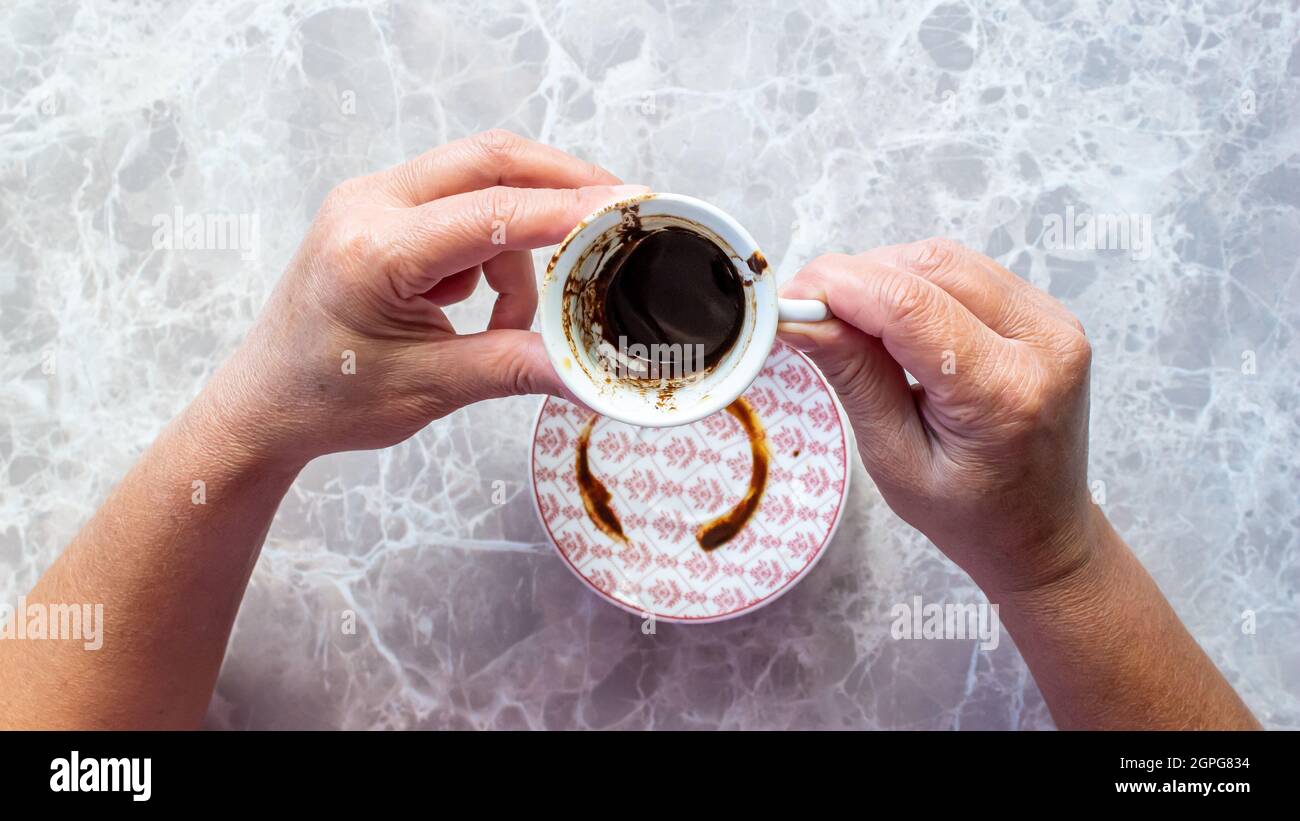 Fortune telling. Woman holding Turkish coffee and fortune telling Stock