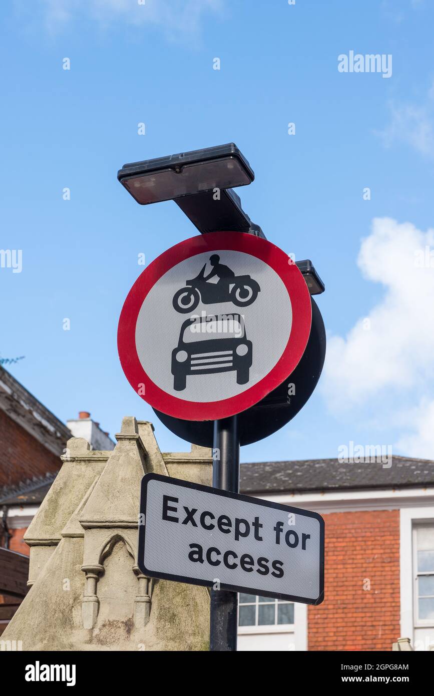 Round road sign with red circle saying no entry for cars or motorcycles except for access.No motor vehicles Stock Photo