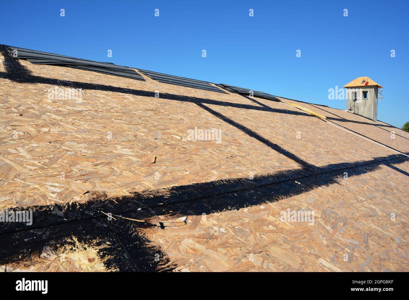 Roofing Construction. Roofing preparation asphalt shingles installing on  house construction wooden roof with bitumen spray. Roofing construction.  Inst Stock Photo - Alamy