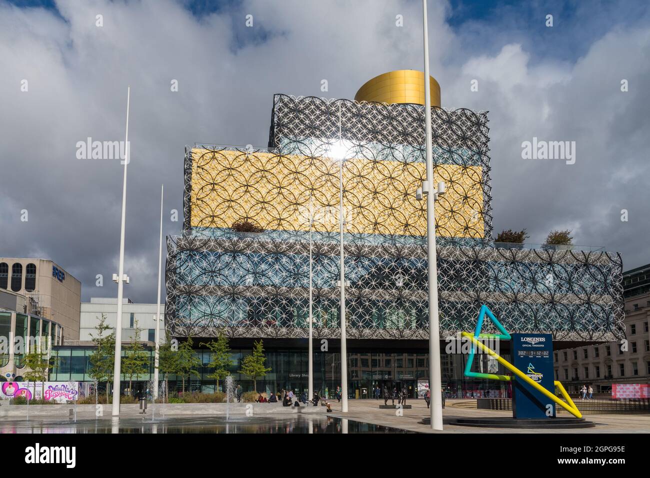 The Longines clock counting down the hours and days to Commonwealth Games 2022 in front of Library of Birmingham, Centenary Square Stock Photo