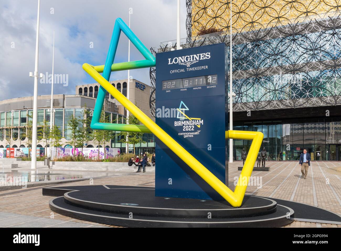 The Longines clock counting down the hours and days to Commonwealth Games 2022 in front of Library of Birmingham, Centenary Square Stock Photo