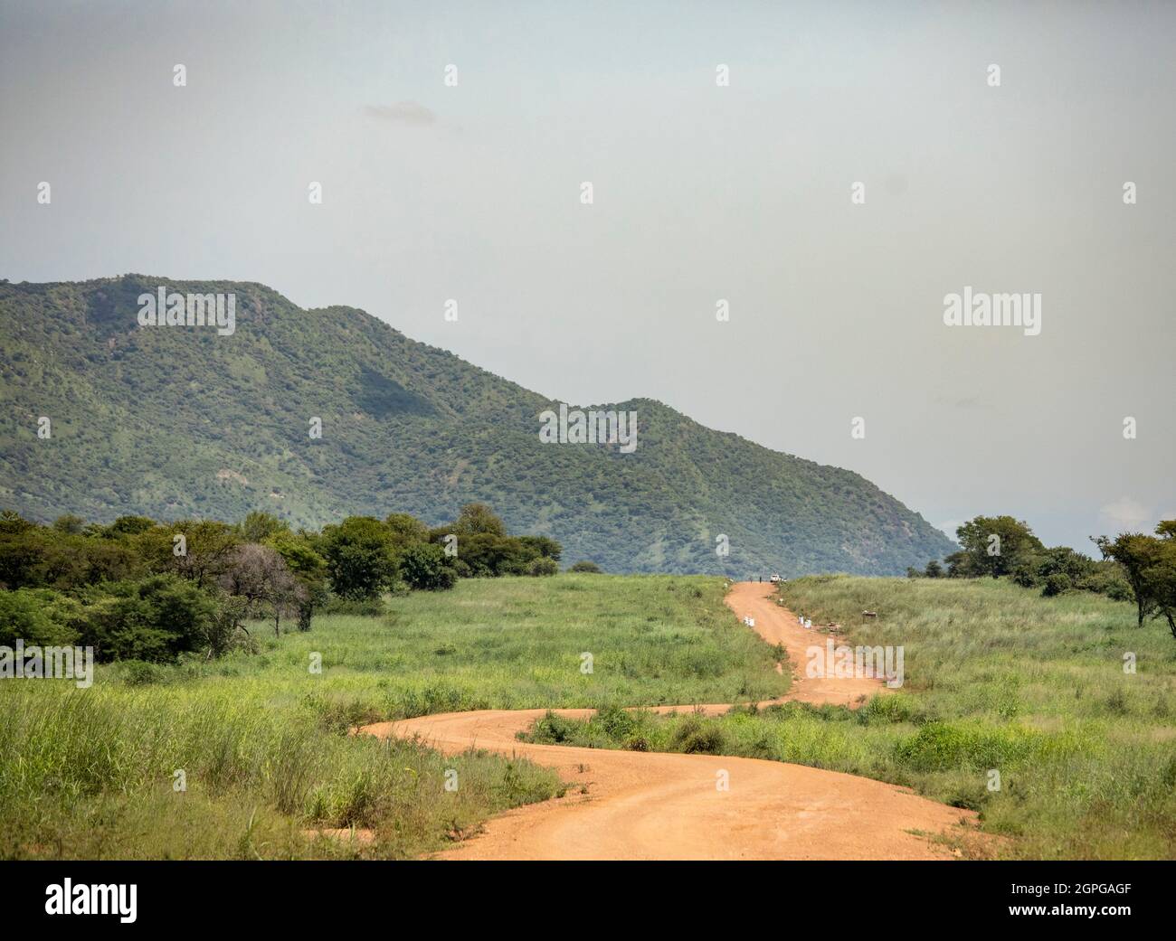 Winding dirt road through the Imatong Mountains of South Sudan. Stock Photo