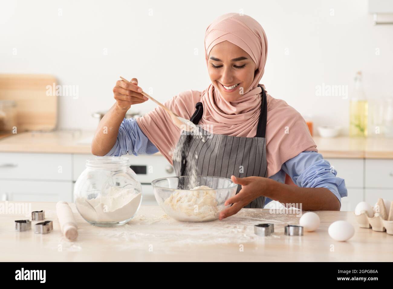 Happy Muslim Woman In Hijab Baking In Kitchen, Preparring Dough For ...